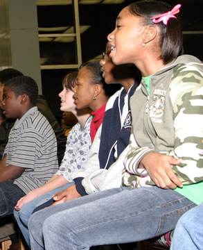 Row of seated children at choir practice. 